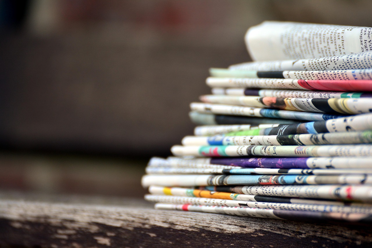 Newspapers, pile of newspapers, press — Singapore Property Investment Exit Strategies: When and How to Maximize Profit in 202