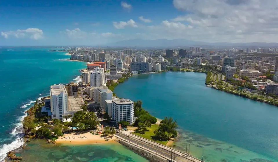 Aerial view of a coastal city in Puerto Rico with buildings and a beach